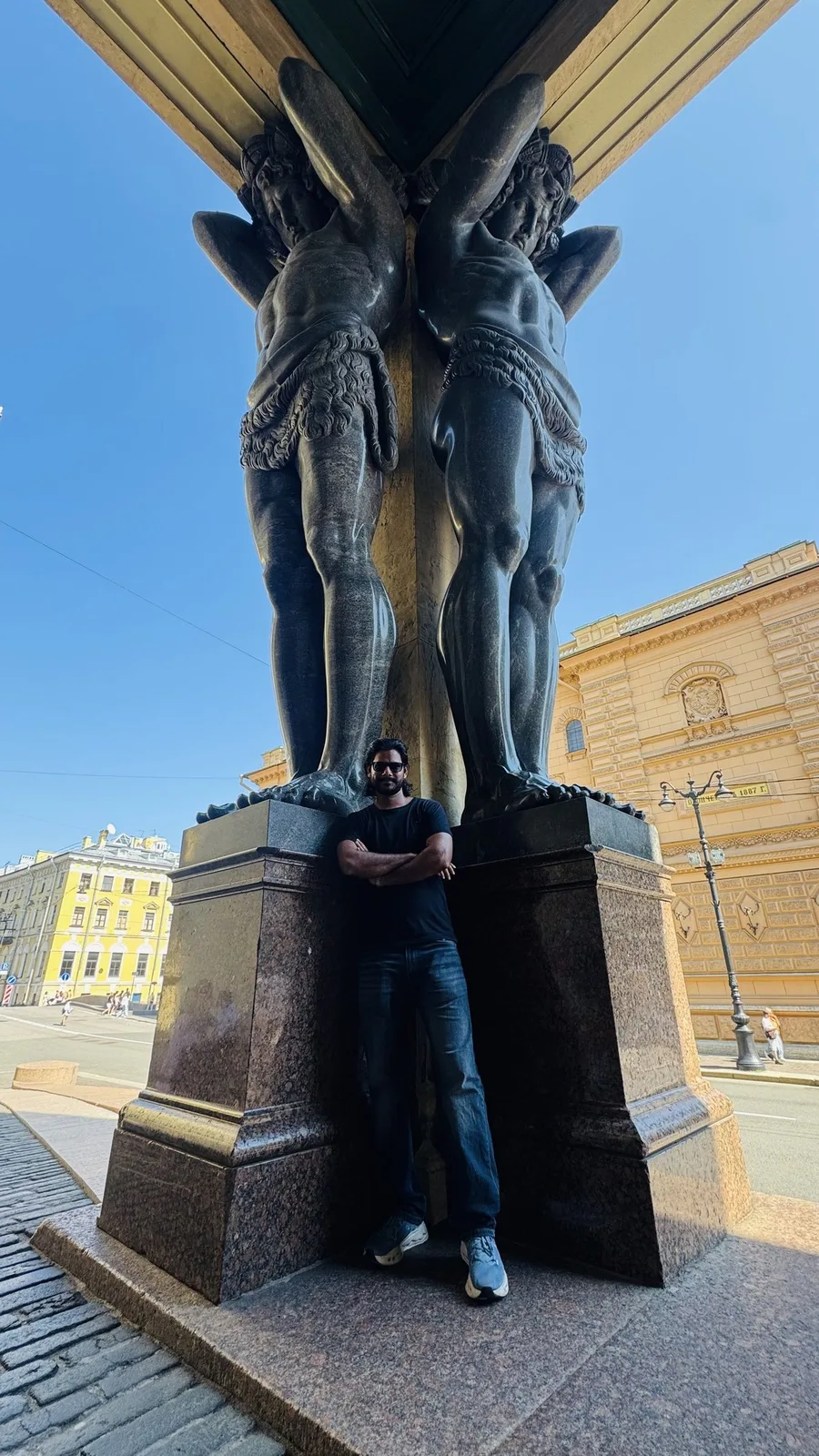 Gautam Kumawat at the plinth of a bronze statue of a man wrestling a rearing horse