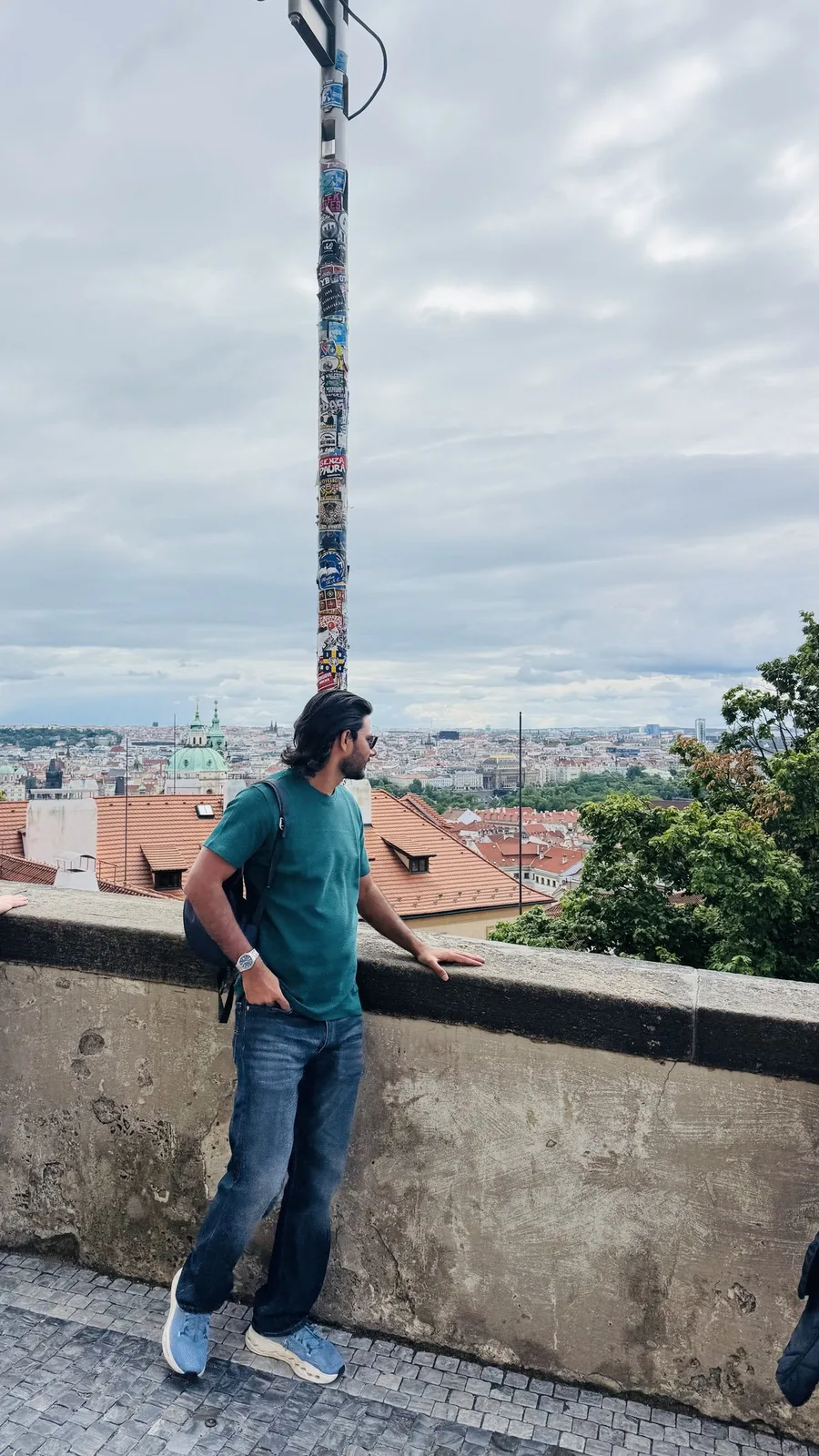 Gautam Kumawat at a parapet above a city of red tiled rooftops